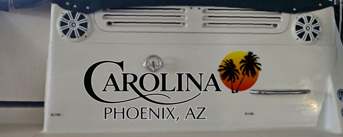Carolina boat name design on a boat transom at sunset with palm trees.